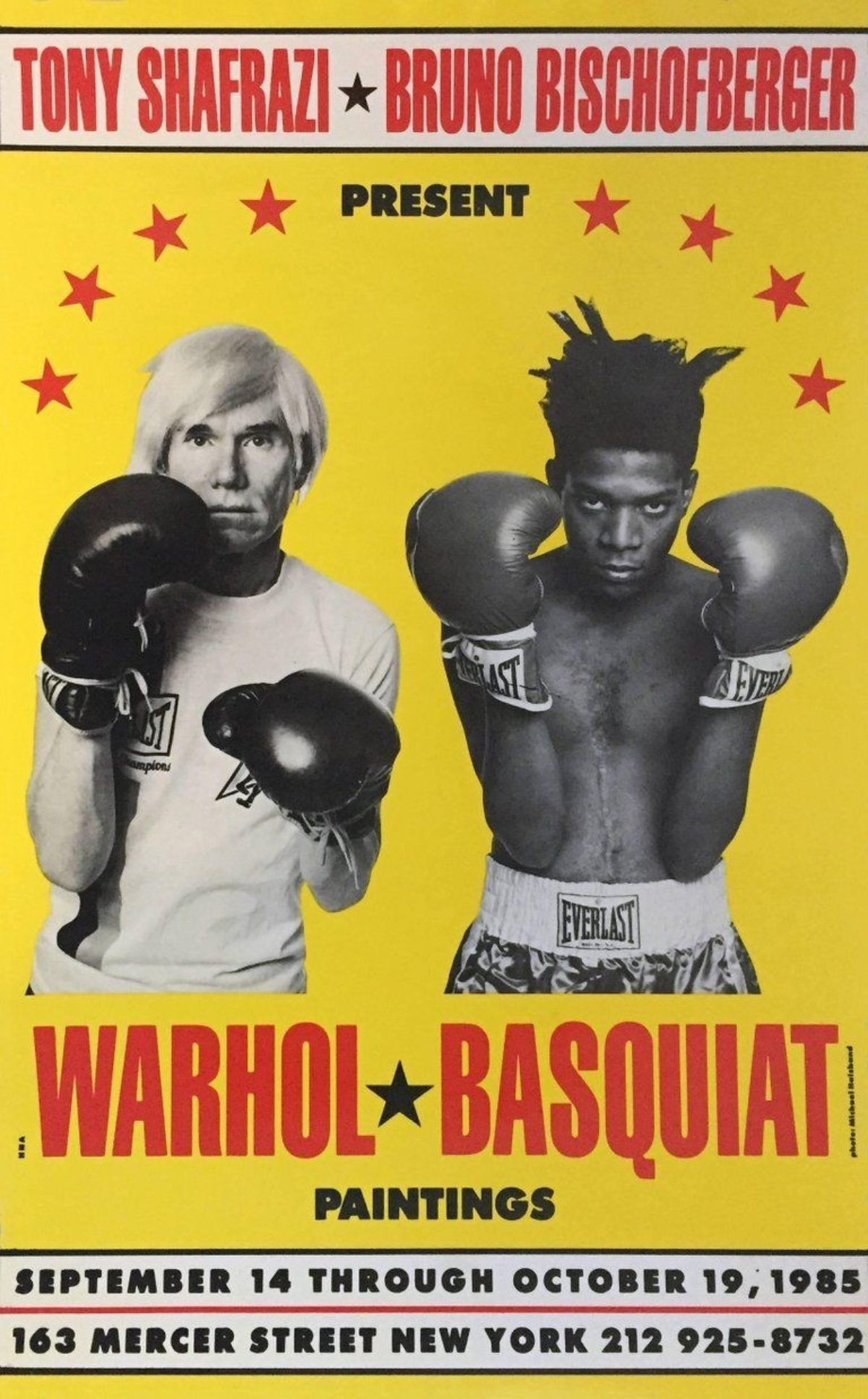 A yellow poster of Andy Warhol and Jean Michel Basquiat in boxing attire and boxing gloves.