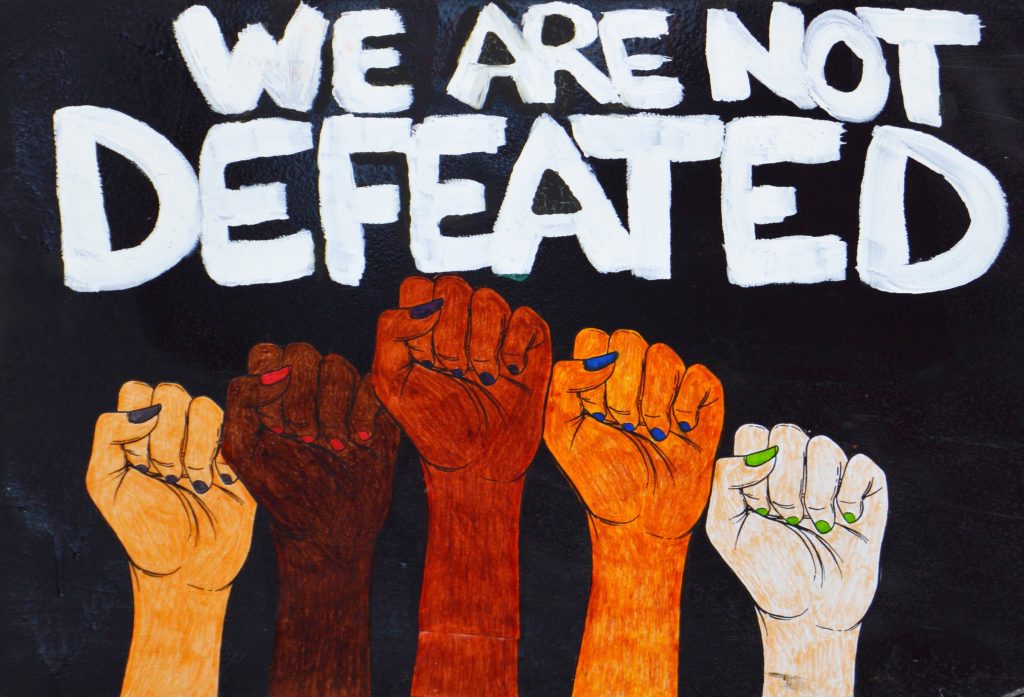 A black poster with 5 illustrative fists in the air with white hand written text.