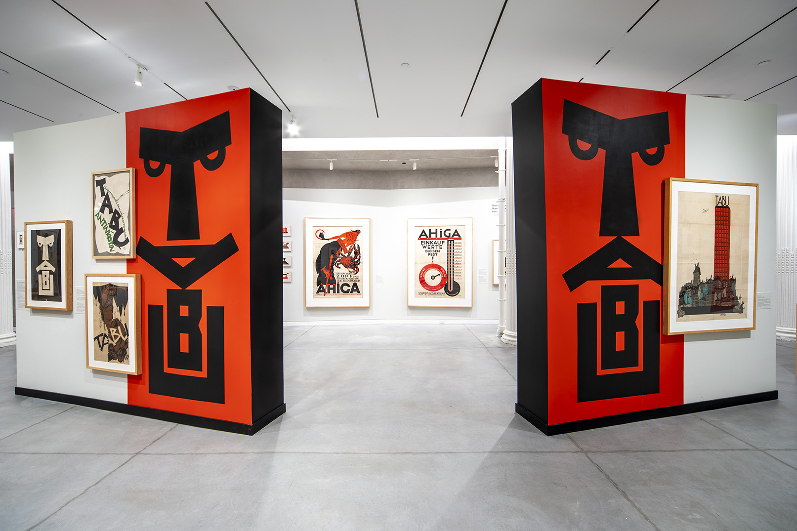 A Julius Klinger show displaying two separate freestanding walls at an entrance forming a face by stacking letters TABU at each end.