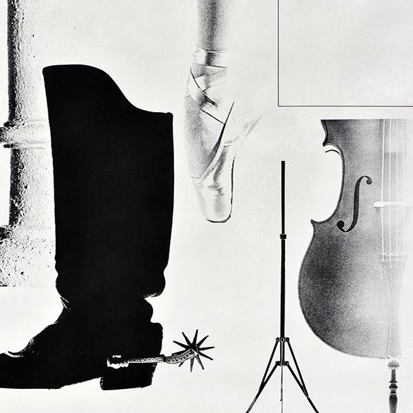 black and white image including boots, ballet shoes, and a cello