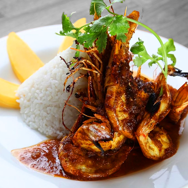 A shrimp, rice, cilantro and mango dish.