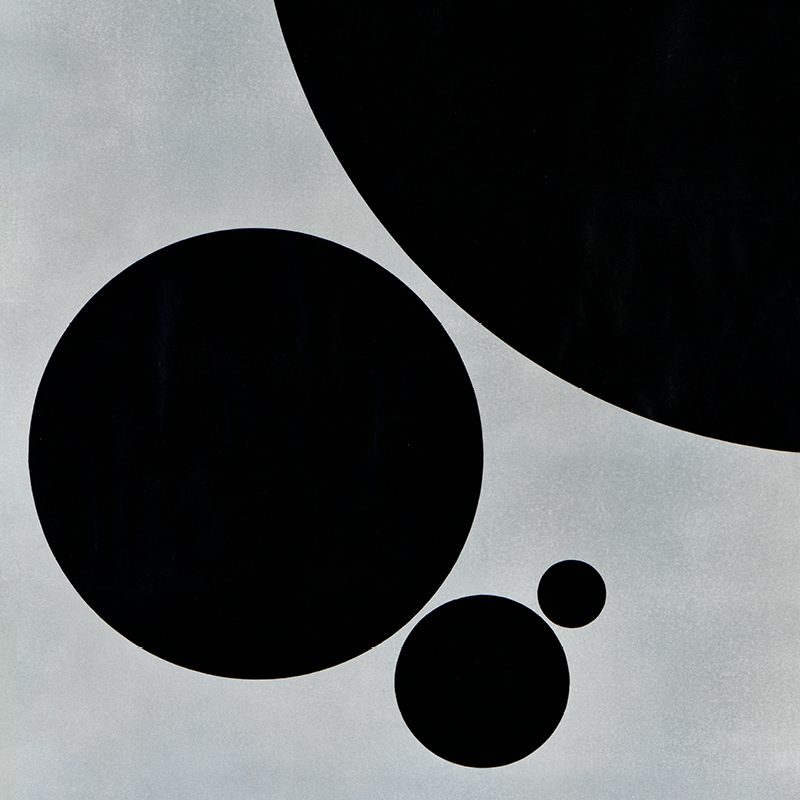 illustrational poster of four black circles of various sizes on a grey background
