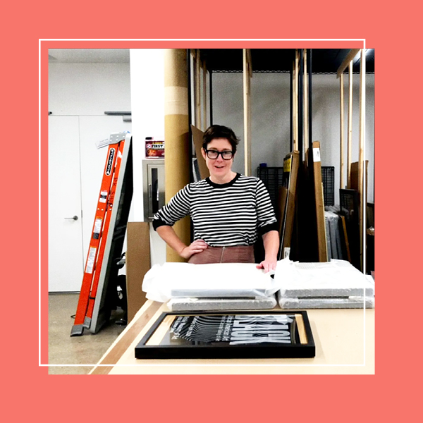 A photo of the archives room in Poster House with the Collections Manager in the center looking at the camera, surrounded in a peach frame.