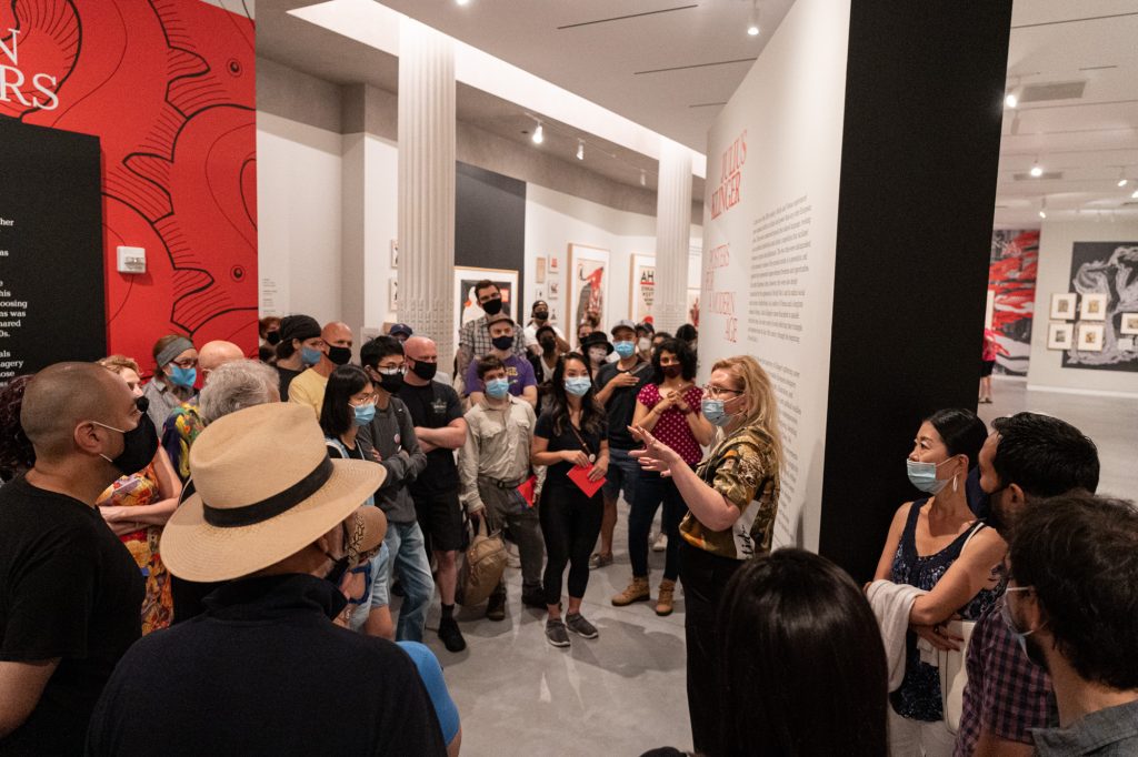 The chief curator addressing a crowd at the Julius Klinger exhibition.