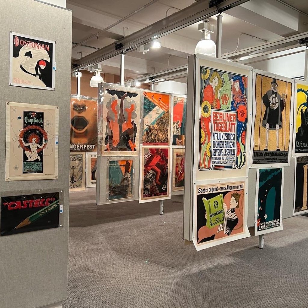 a photograph of a gallery of framed posters from various time periods.