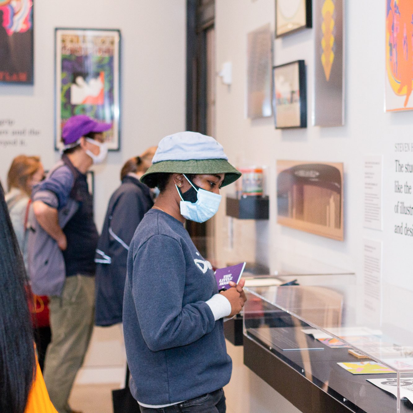 A woman looking at a glass display case.