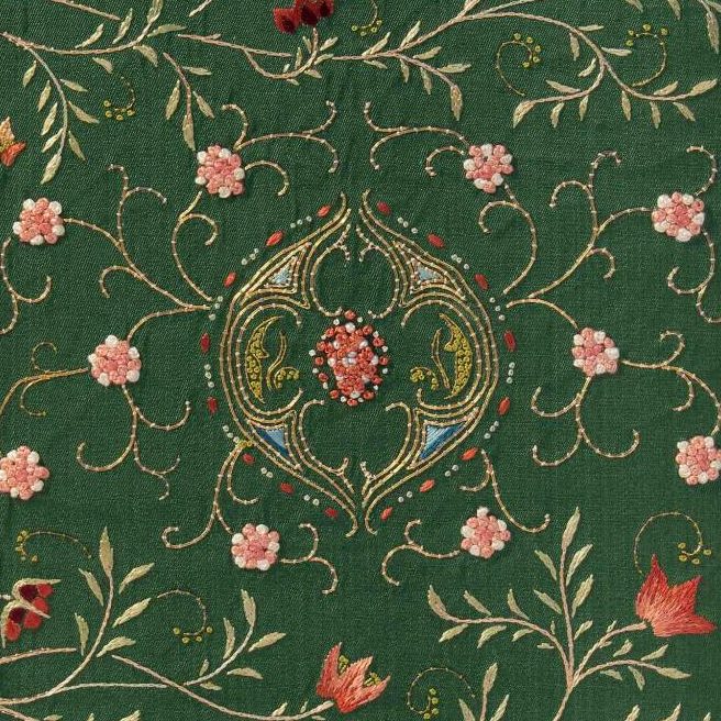 A green book cover with flower embroidery