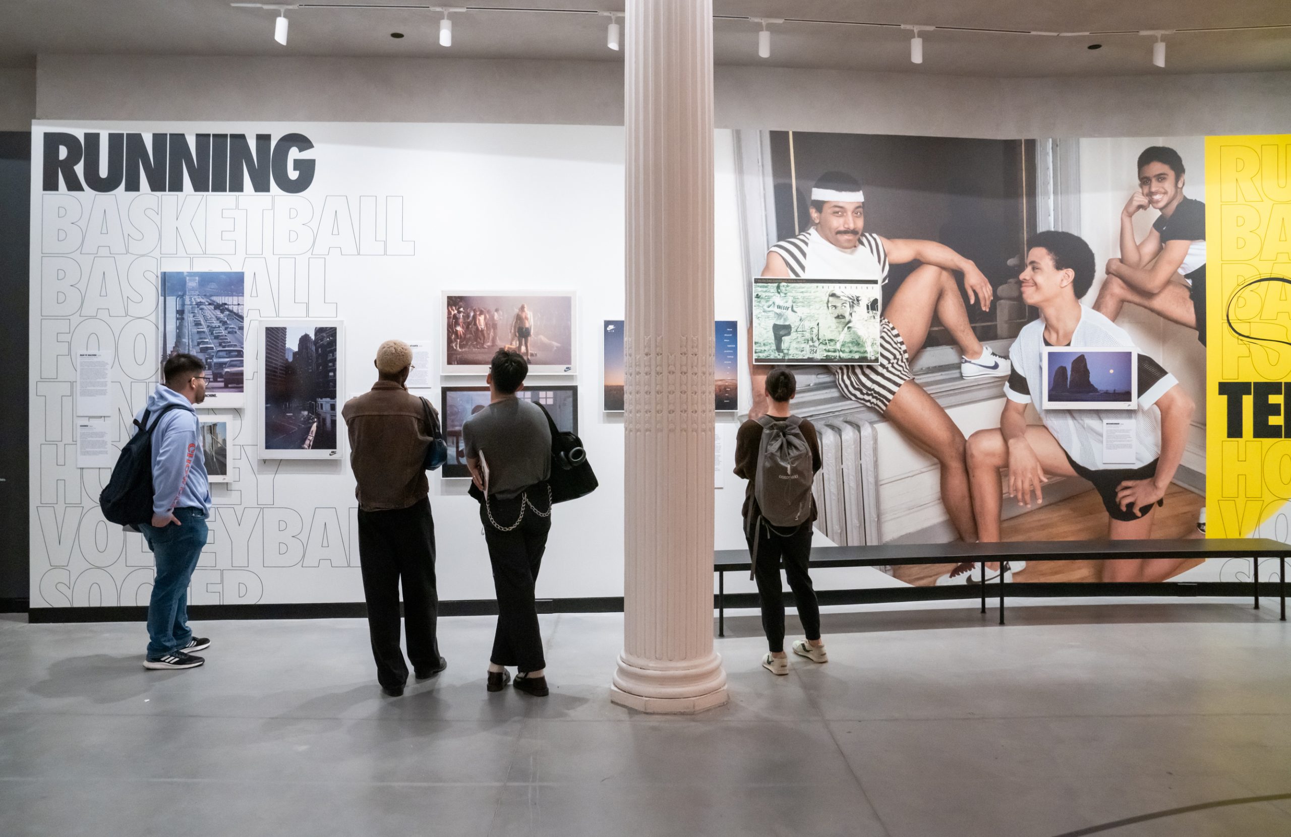 students in the gallery interacting with posters in the Nike show