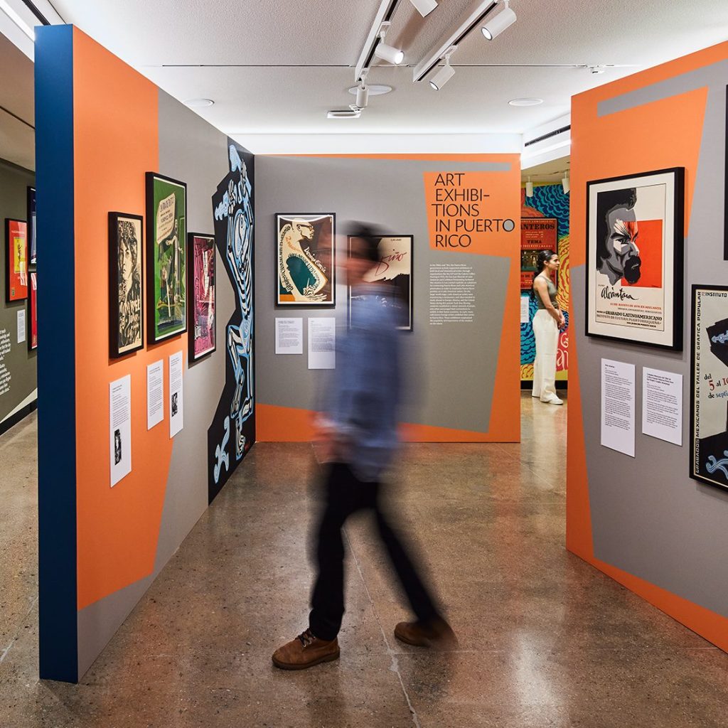 A photo of two people walking through a museum gallery