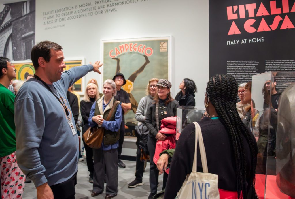 Image of a tour guide giving a tour to a group of people.