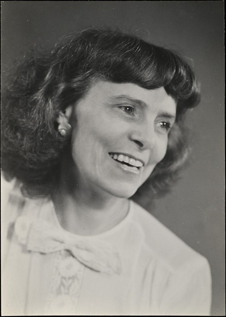 Black and white image of a woman smiling.