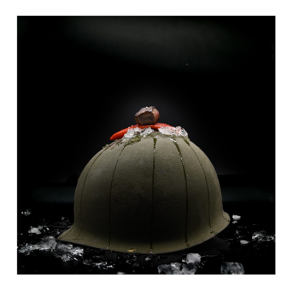 Image of an army helmet with beef and pepper on a bed of ice on top of it.