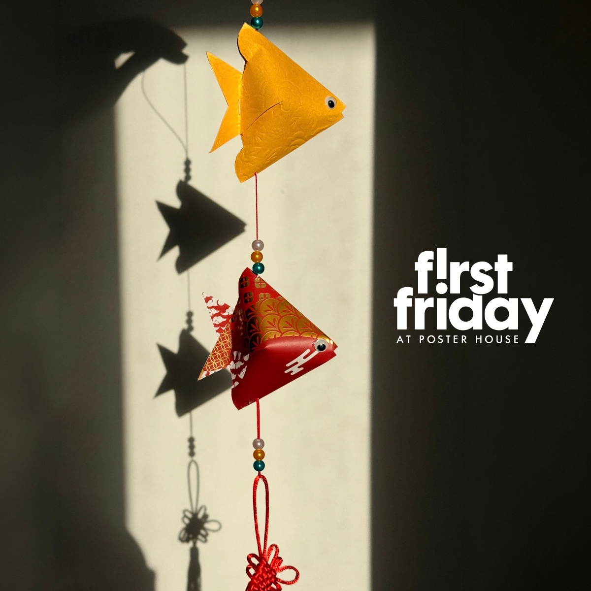 a mobile made of one yellow and one red origami fish