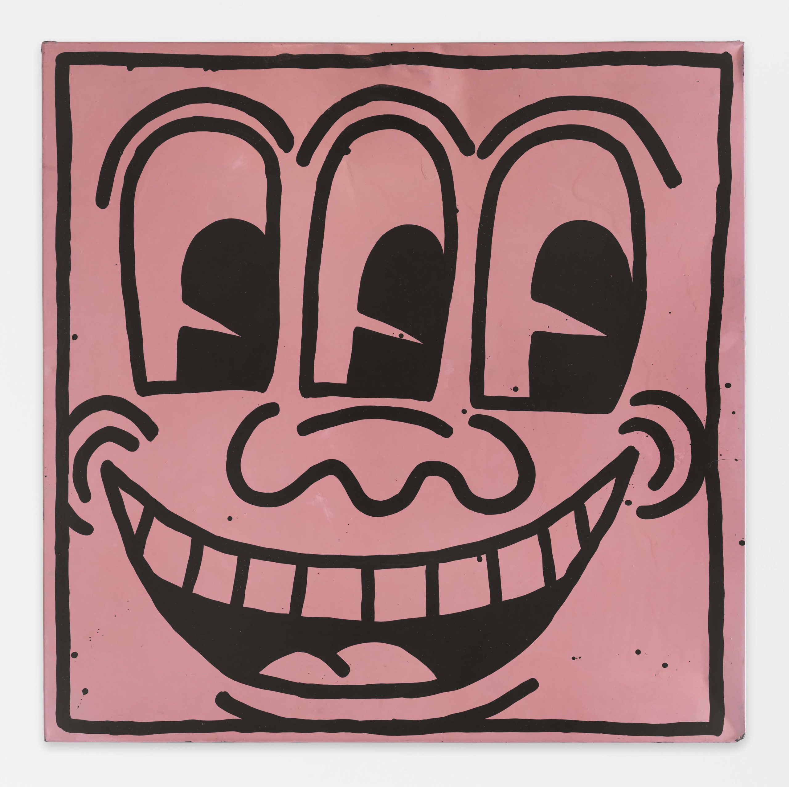a cartoon face with three eyes and a wide smiles drawn in think black lines on a mauve colored square
