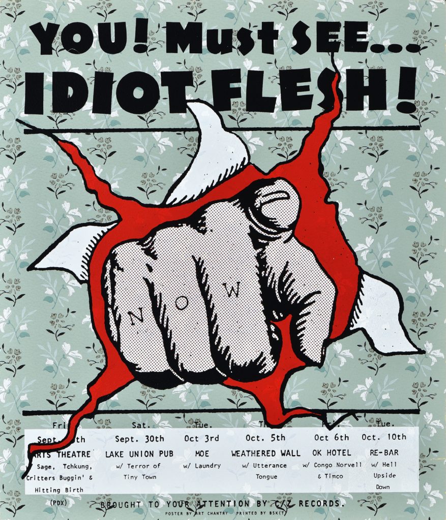 Poster of a hand bursting through a piece of paper, pointing at the viewer.