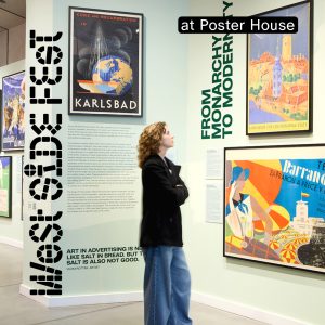 A person gazing up at art on the walls of a gallery.