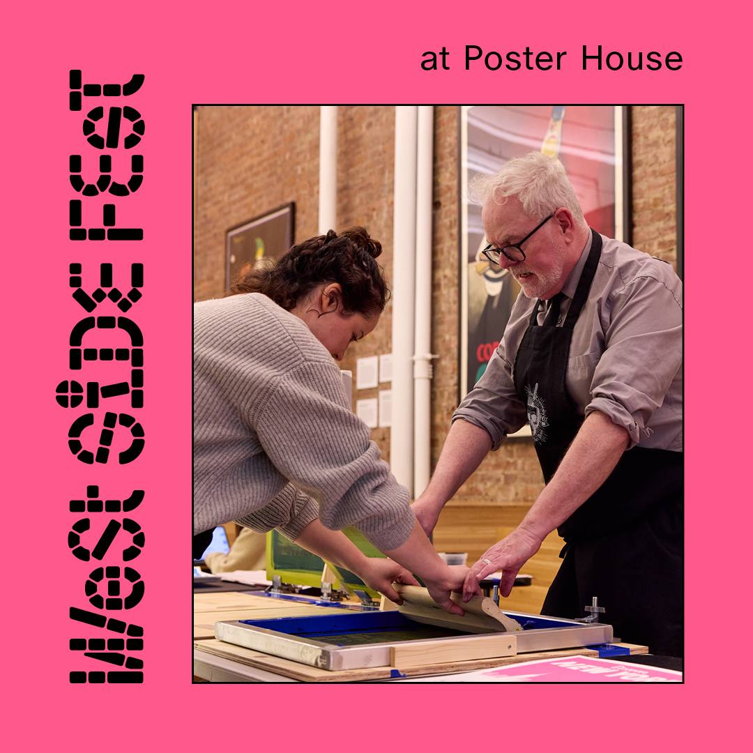 Two people leaning over a table making a screenprint.