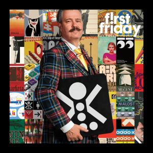 A man with a mustache wearing a plaid suit standing in front of a colorful wall of posters.