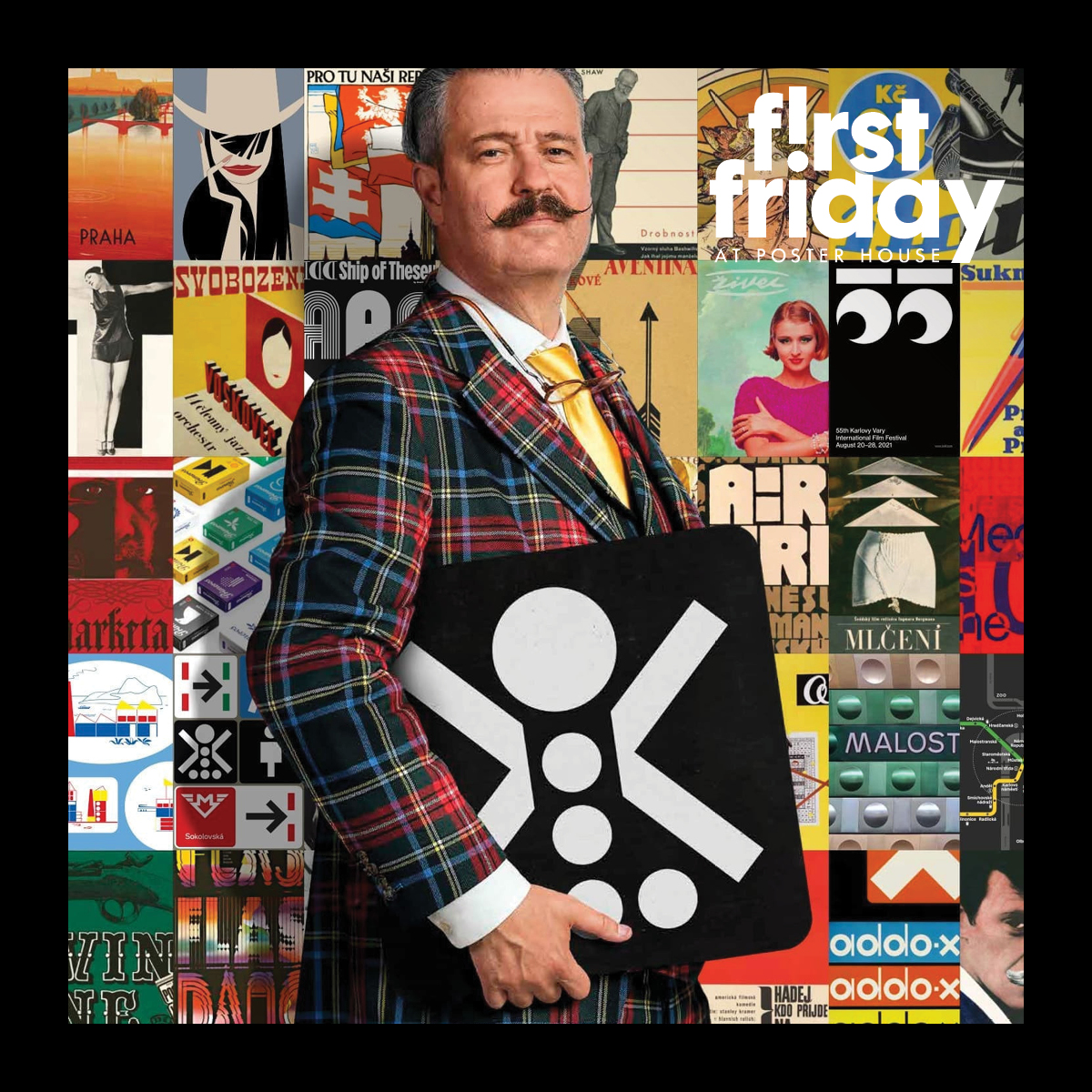 A man with a mustache wearing a plaid suit standing in front of a colorful wall of posters.