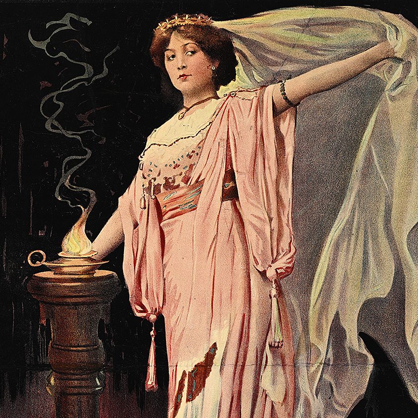 A woman in a draped pink dress and a billowing white veil standing next to a flame, set against a black background.