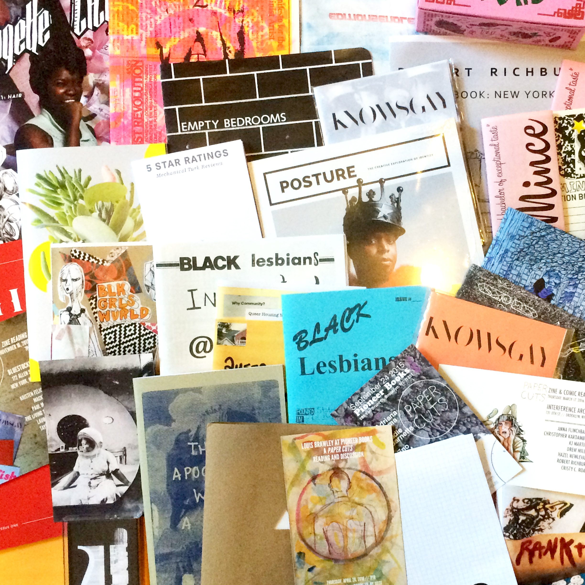 A pile of several colorful zines.
